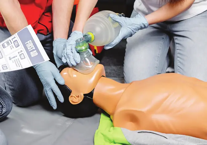 Workplace first aid training with a resuscitation mannequin